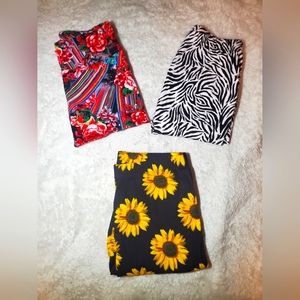 3 pairs of No Boundaries printed leggings between sizes small and medium.
